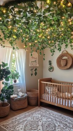 Nursery with a ceiling covered in hanging greenery and soft fairy lights, creating a forest canopy effect above a wooden crib. Fairy Forest Nursery, Green Nursery Ideas, Enchanted Forest Nursery, Nature Inspired Nursery, Canopy Ceiling, Fairy Nursery, Dreamy Nursery, Magical Woodland, Cozy Nursery