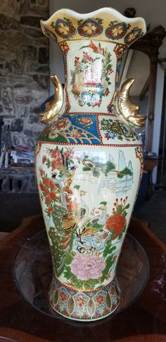 an ornate vase sitting on top of a wooden table