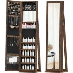 an open wooden medicine cabinet next to a mirror with jewelry hanging on the door and necklaces in it