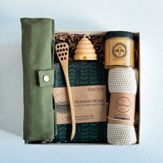 the gift box contains several items such as a spoon, cup, and napkins