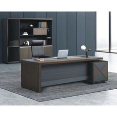 an office desk with a laptop on it in front of a bookcase and bookshelf