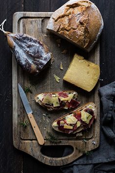 bread, meat and cheese are on a cutting board