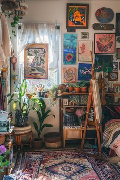 a room filled with lots of pictures and plants on the wall next to a window