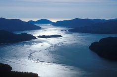 an aerial view of the ocean and mountains