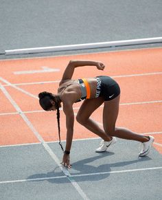 a woman bending over on a tennis court