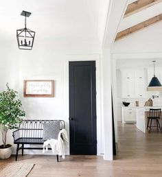 a living room filled with furniture and a black door