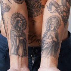 a man with tattoos on his arms and chest is holding out his hands for the camera