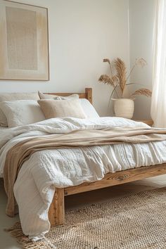 a bed with white linens and pillows in a bedroom next to a large window