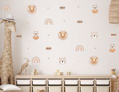 a child's room with wall decals and toys on the dresser next to it