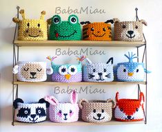 several crocheted animal baskets are on a shelf