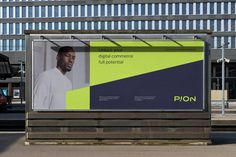 a bus stop with a large advertisement on it's side in front of a building