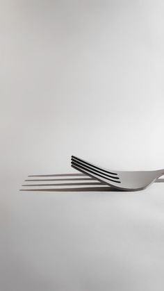 three forks are stacked on top of each other in the shape of four straight lines