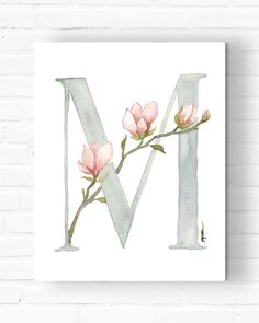 the letter m with pink flowers is shown on a white brick wall, and it's painted in watercolor