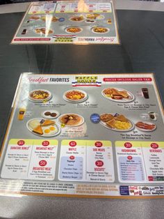 two menu boards with different types of breakfast foods on them, sitting on a table