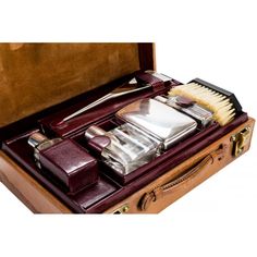 an open suitcase with various items in it including a brush and other things to use for grooming