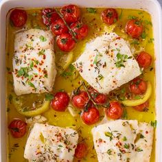 fish with tomatoes and herbs in a white casserole dish, ready to be eaten