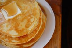 pancakes with butter and syrup on a white plate