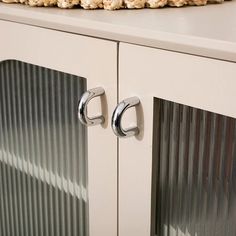 a close up of a cabinet with two handles