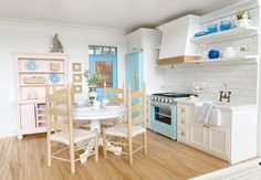 a model kitchen and dining room in a doll's house, with blue accents