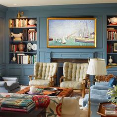 a living room filled with furniture and bookshelves