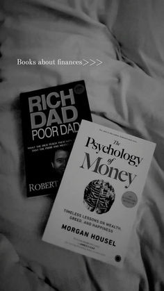 two books sitting on top of a bed next to an unmade sheet with the words rich dad poor dad