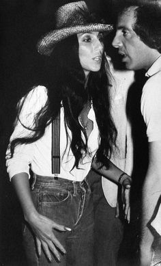 black and white photograph of man and woman wearing hats, standing next to each other