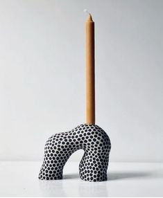 a candle that is sitting in the shape of an elephant's head with polka dots on it