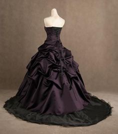 Deep plum purple over a black skirt make this an elegant choice for a Halloween or Gothic style wedding. The sleeveless corset style top has black beaded lace appliques. The full skirt (crinoline recommended for full effect) is elegant tufts of taffeta cascading over a black court skirt with court style train. Simply stunning! Dress is lovingly handmade to order and takes approximately 4-6 weeks to complete. Rush orders are available depending on the time of year. Please send a private messa... Plum Wedding Dresses, Purple And Black Wedding, Black And Purple Wedding, Classy Halloween Wedding, Halloween Wedding Dresses, Wedding Dresses Taffeta, Black Wedding Dress, Black Ball Gown