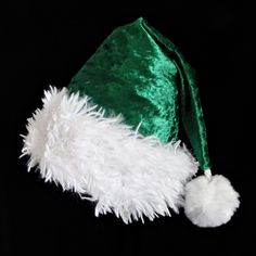 a green and white santa hat on top of a black background with fluffy white fur