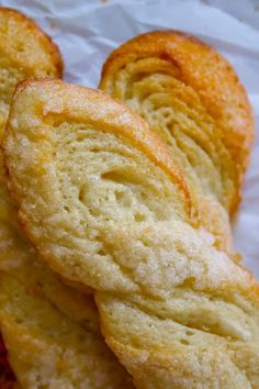 several pieces of bread sitting on top of white paper