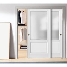 an open closet with white doors and clothes hanging on the shelves in front of it