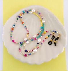 For more chains, check out these listings: https://www.etsy.com/no-en/shop/Pearlsbymimmi?ref=simple-shop-header-name&listing_id=935334066&section_id=32595269 Delicate and colorful eyeglass and mask chain. I made it to look colorful and happy and allow you to wear your mask og glasses around your neck when not in use. Its also make a colorful long necklace. Silicone ends are adjustable to fit most glasses. Lobster claw attachments make it easy to replace silicone ends after too much wear & tear. Chain Sunglasses, Eyeglass Necklace, Custom Glasses, Sunglasses Chain, Mask Chain, Sunglass Chain, Mascara Facial, Eyeglass Chain, Necklace Pearl