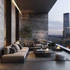 a living room with couches and tables on top of the floor in front of a cityscape