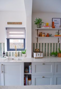 the kitchen is clean and ready for us to use it's counter tops are white