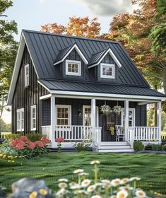 a black and white house with flowers in the front yard