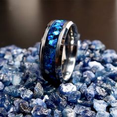 "The Sapphire Storm Ring, Tungsten Titanium Carbide Sapphire Blue Opal Engagement Ring, Glow in the Dark Wedding Band for Men & Women This is the Sapphire Storm Ring, made with Sapphire and Cobalt Blue Opal on a black blue background. Meant to be the counter to the Lava Rock Ring, everything is the opposite from the colors to the glow being blue. The Sapphire adds depth to the ring while the Opal takes center stage with its different blue/green hues and flashes The ring will come in your choice Luxury Blue Men's Wedding Ring, Royal Blue Wedding Rings For Men, Luxury Blue Men's Ring For Wedding, Glow In The Dark Mens Ring, Glow Wedding Ring, Cheap Blue Rings For Wedding, Male Engagement Ring Saphire, Mens Wedding Rings With Saphire, Glow In The Dark Wedding