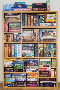 a wooden book shelf filled with lots of different types of books on top of it