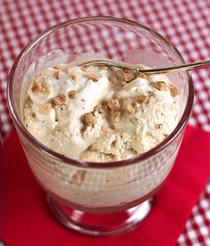 a bowl filled with ice cream sitting on top of a red and white checkered table cloth