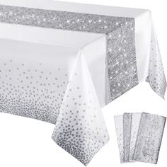 a white tablecloth with silver sequins on it and two napkins next to it