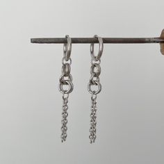 Add an edgy touch to your everyday look with these stunning chain earrings in stainless steel. These versatile earrings are perfect for adding a minimalist yet modern flair to any outfit. Handcrafted with high-quality stainless steel, they are durable, hypoallergenic, and will last for years to come. Whether you're heading to work or a night out with friends, these chain earrings are sure to make a statement. Treat yourself or a loved one to these chic and trendy earrings that are sure to become Diy Chain Earrings, Earrings Grunge, Diy Chain, Edgy Earrings, Grunge Jewelry, Silver Chain Earrings, Chain Earring, Wire Wrapped Earrings, Trendy Earrings