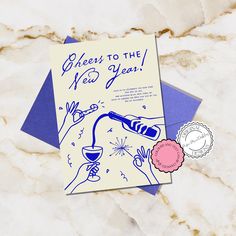 a blue and white greeting card with an image of a wine glass being poured on it