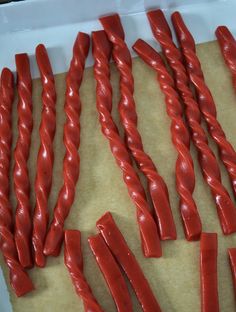 some red candles are laying out on a piece of paper and ready to be lit