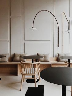 an empty restaurant with wooden tables and chairs