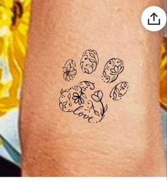 a dog's paw is shown with flowers and leaves on the side of it