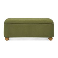 an upholstered bench with wooden legs and a green cover on the top, in front of a white background