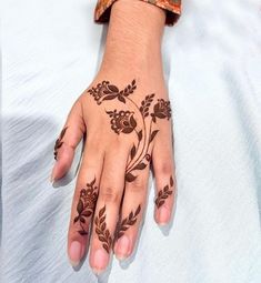 a woman's hand with henna tattoos on it