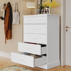 a white chest of drawers in a room