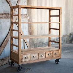 an old wooden shelf with drawers on wheels