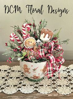 a bowl filled with candy and cookies on top of a lace doily covered table