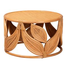 a round wooden table with wicker leaves on it